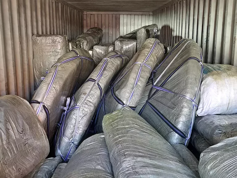 Inside of a container loaded with packed yurt parts