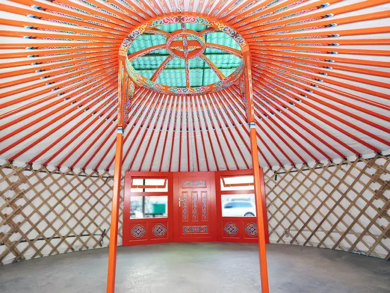 Interior of Mongolian yurt in orange painting with traditional motif decoration