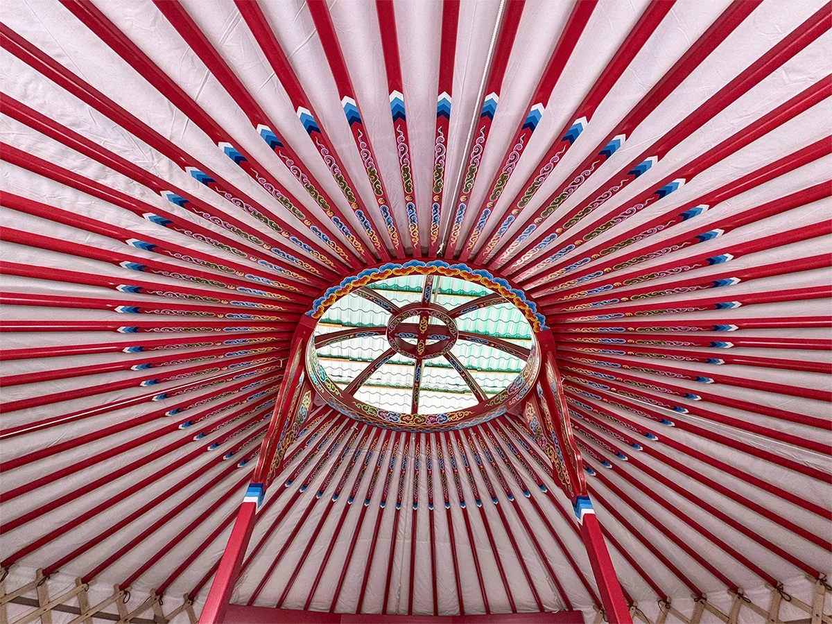 A yurt painted with red color and decorated with traditional patterns