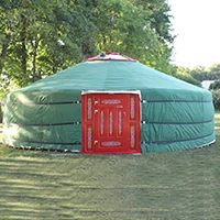 A large Mongolian yurt with green outer cover and red door