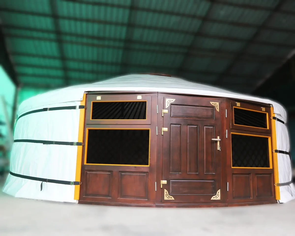 A Mongolian yurt with white cover and brown door