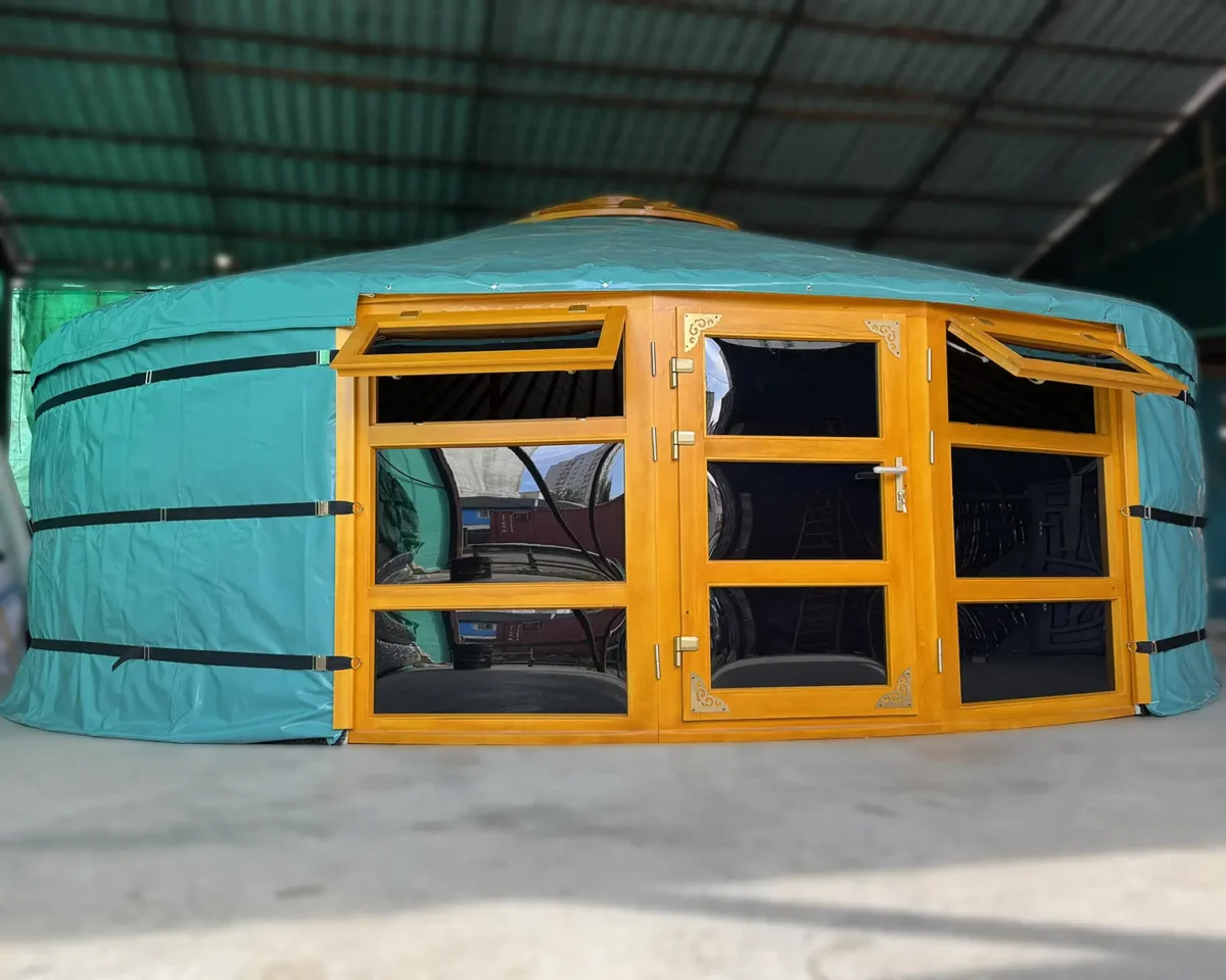 A Mongolian yurt with two front windows, windows and door are all made of glass, in green cover.