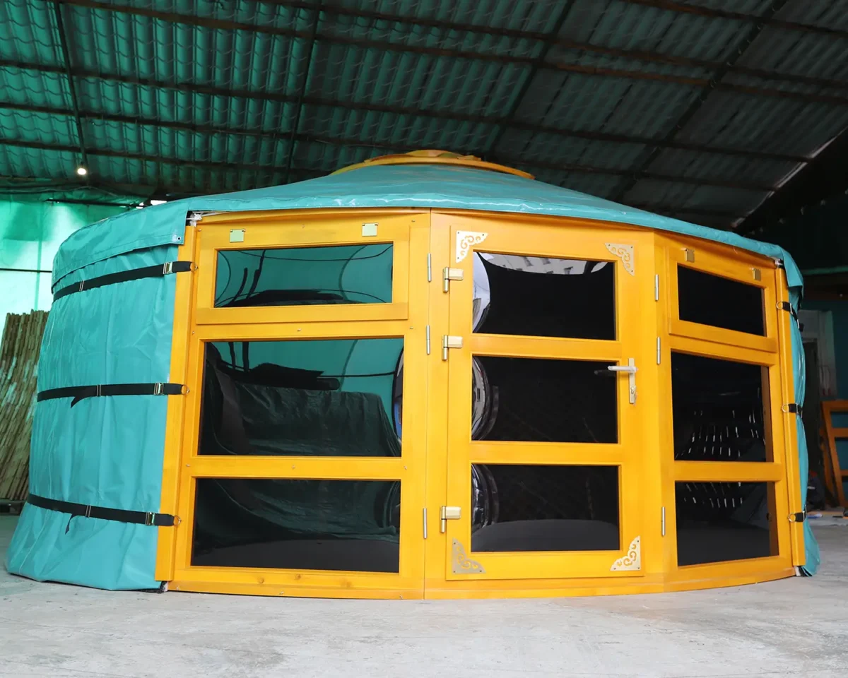 A Mongolian yurt with large glass windows painted in yellow color