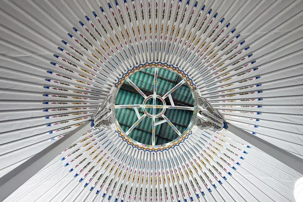 Mongolian yurt with white interior with traditional motif decoration